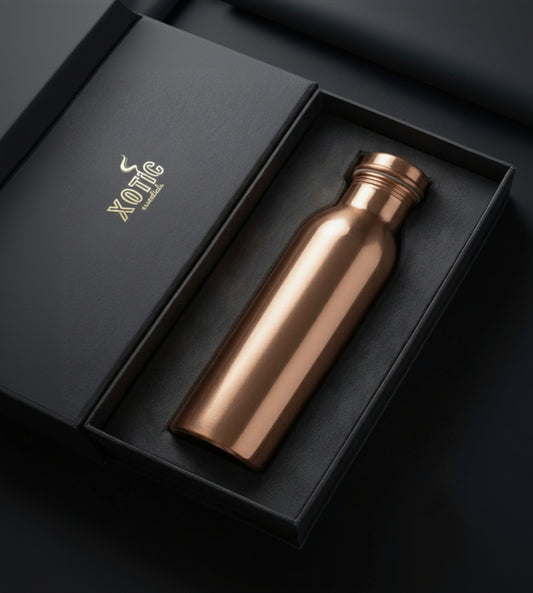 Rose gold water bottle in a black box with 'Xotic' branding.