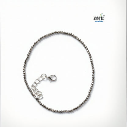 Silver beaded bracelet on a white background with 'Xotic' branding.