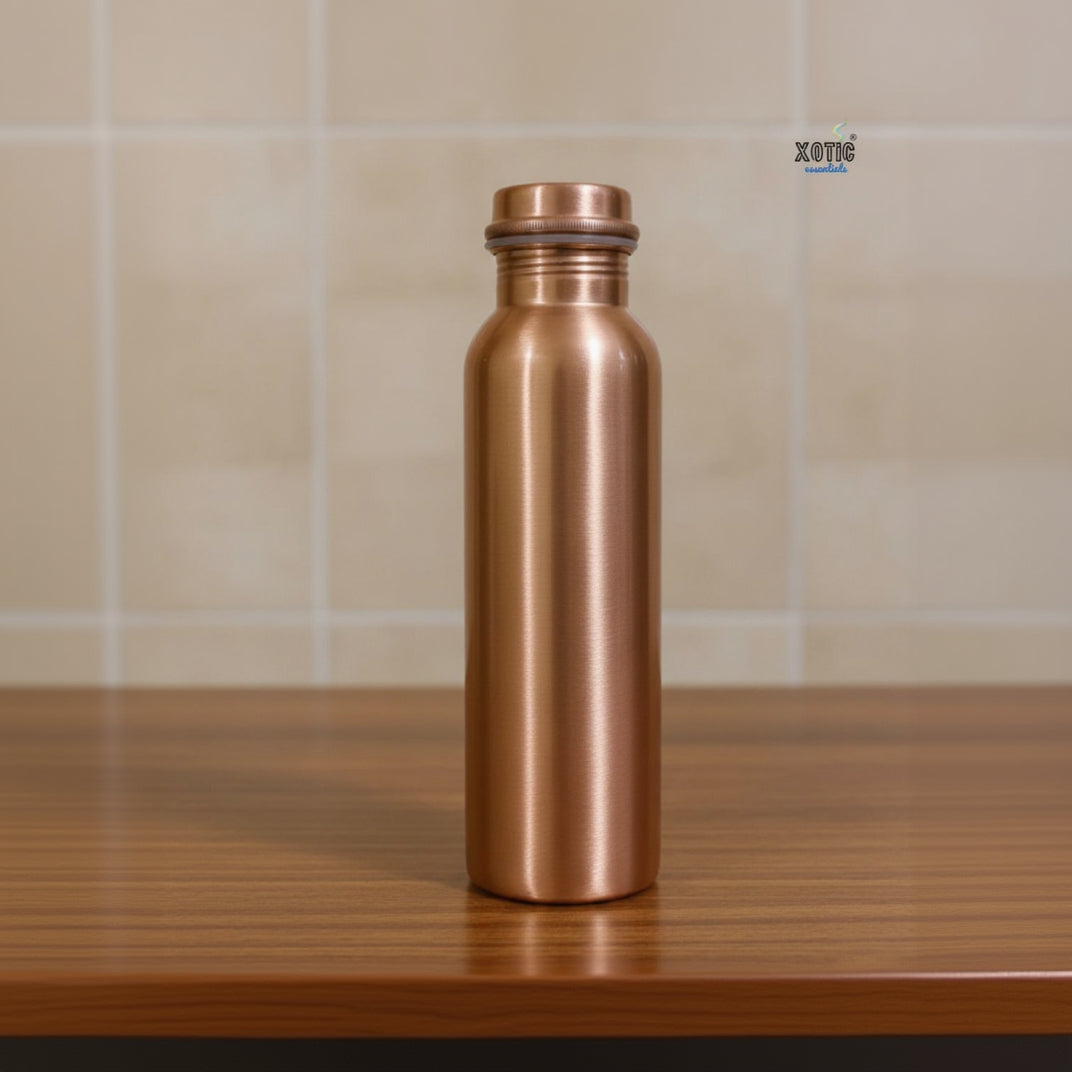 Copper water bottle on a wooden surface with a tiled wall background